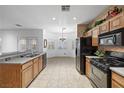 Bright eat-in kitchen featuring tile floors, stainless steel appliances, and a dining area at 4114 Jessica Marie St, North Las Vegas, NV 89032