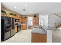 Traditional kitchen with wood cabinetry, stainless steel appliances, and a breakfast bar at 4114 Jessica Marie St, North Las Vegas, NV 89032