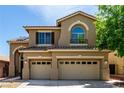 Two-story home features a three-car garage and covered porch at 432 Emerald Heights St, Las Vegas, NV 89144