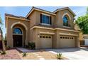 Two-story home features a three-car garage, covered porch and desert landscaping at 432 Emerald Heights St, Las Vegas, NV 89144