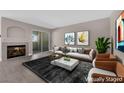 Cozy living room with fireplace, plush seating, and sliding door access to outdoor space at 4324 W Lake Mead Blvd # 202, Las Vegas, NV 89108