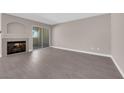 Bright living room featuring a fireplace, sliding glass door, and wood-look flooring at 4324 W Lake Mead Blvd # 202, Las Vegas, NV 89108