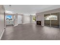 Spacious living room with wood-look flooring, fireplace, and lots of natural light at 4324 W Lake Mead Blvd # 202, Las Vegas, NV 89108