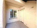 Cozy front porch with a window and door, unit number 103 at 4675 Basilicata Ln # 103, North Las Vegas, NV 89084