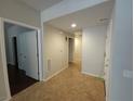 Inviting hallway with tile flooring, leading to various rooms at 4675 Basilicata Ln # 103, North Las Vegas, NV 89084