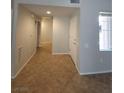 Tiled hallway with natural light and a front door view at 4675 Basilicata Ln # 103, North Las Vegas, NV 89084