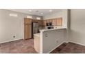 Functional kitchen features oak cabinets, stainless steel appliances, and tiled flooring at 4705 Delicate Arch Ct, North Las Vegas, NV 89031
