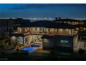 Night view of the backyard featuring a luxurious pool, spa, and panoramic city views with illuminated city lights at 5 Crystal Tree Pass, Henderson, NV 89052