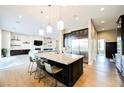 Open-concept kitchen with large island, stainless steel appliances, and modern finishes throughout at 5 Crystal Tree Pass, Henderson, NV 89052