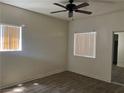 Bright bedroom featuring wood-look flooring, two large windows, and neutral paint at 5170 S Jones Blvd # 108, Las Vegas, NV 89118