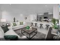 Open-concept layout with a cozy living area flowing into a well-equipped kitchen with breakfast bar seating at 5761 Crenellated St # Lot 60, Las Vegas, NV 89148
