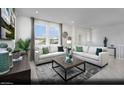Bright living room with two sofas, large windows, neutral color palette, and modern decor at 5761 Crenellated St # Lot 60, Las Vegas, NV 89148