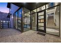 Inviting entrance with large glass doors, modern staircase, and stylish interior design at 577 Overlook Rim Dr, Henderson, NV 89012