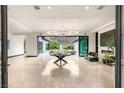 Elegant open living area with unique chandeliers and seamless indoor-outdoor flow to the pool at 584 Saint Croix St, Henderson, NV 89012