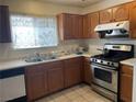 Cozy kitchen with stainless steel appliances and wooden cabinets at 6086 Sunken River Trl, Las Vegas, NV 89118