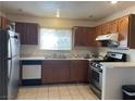 Traditional kitchen featuring wooden cabinets, stainless steel appliances, and ample counter space at 6086 Sunken River Trl, Las Vegas, NV 89118