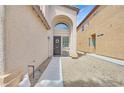 Inviting entryway with arched alcove, decorative door wreath, and low-maintenance desert landscaping at 6717 Lincoln Wood St, Las Vegas, NV 89149