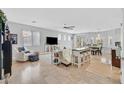 Bright, open-concept living area with travertine flooring, neutral decor, and ample natural light at 6717 Lincoln Wood St, Las Vegas, NV 89149