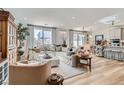 Bright and airy living room with a comfortable sectional sofa, stylish decor, and large windows providing ample natural light at 6938 Feather Hill St, North Las Vegas, NV 89086