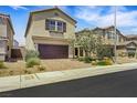 Charming two story home with desert landscaping, brick driveway, and an attached garage at 7011 Toll Mountain St, North Las Vegas, NV 89086