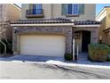 Two-story home with stone accents and a two-car garage at 7563 Captain Lord Ct, Las Vegas, NV 89166