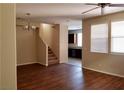 Open living room with stairs, wood floors, and two windows at 7563 Captain Lord Ct, Las Vegas, NV 89166