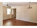 Bright living room with ceiling fan, dark wood floors, and neutral walls at 7563 Captain Lord Ct, Las Vegas, NV 89166