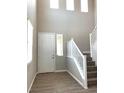 Bright entryway with hardwood floors, high ceilings, and a staircase bathed in natural light at 7861 Hamilton Pool Dr, Las Vegas, NV 89113