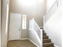 Inviting entryway with hardwood floors, high ceilings, and a staircase leading to the upper level at 7861 Hamilton Pool Dr, Las Vegas, NV 89113