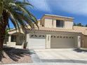 Beige home showcasing a three-car garage, desert landscaping, and a tile roof at 8432 Apple Hill Ct, Las Vegas, NV 89128