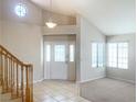 Bright entryway boasts tile flooring, a staircase, and ample natural light from large windows at 8432 Apple Hill Ct, Las Vegas, NV 89128