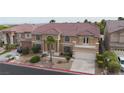 Two-story stucco home featuring a balcony and well-maintained landscaping at 8809 Barium Rock Ave, Las Vegas, NV 89143