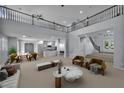 Spacious living room with soaring ceilings, a balcony, and an open-concept design at 8809 Barium Rock Ave, Las Vegas, NV 89143