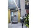 Inviting front entrance with gray door, a wreath, and seating area at 9050 W Tropicana Ave # 1102, Las Vegas, NV 89147