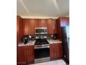 Well-equipped kitchen featuring stainless steel appliances and wooden cabinets at 9050 W Tropicana Ave # 1102, Las Vegas, NV 89147
