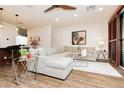 Spacious living area featuring modern decor, a large sectional, and hardwood floors at 9050 W Tropicana Ave # 1102, Las Vegas, NV 89147
