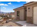 Attractive single-story home with desert landscaping, stone accents, and an attached two-car garage at 942 Shadow Hawk Rdg, Mesquite, NV 89027