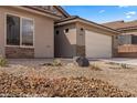 Attractive single-story home with desert landscaping, stone accents, and an attached two-car garage at 942 Shadow Hawk Rdg, Mesquite, NV 89027