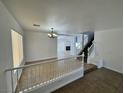 Open-concept living area with staircase, tile flooring, and a view of the lower level at 10574 Salmon Leap St, Las Vegas, NV 89183