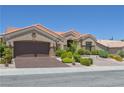 Attractive single-story home with desert landscaping and a terracotta roof with an attached two-car garage at 10632 Clarion Ln, Las Vegas, NV 89134