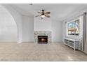 Spacious living room with stone fireplace, ceiling fan, and natural light at 1411 Di Blasi Dr # 104, Las Vegas, NV 89119
