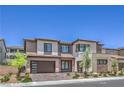 Beautifully landscaped modern two-story home showcasing a two-car garage and desert plants at 201 Carmel Sky St, Las Vegas, NV 89138