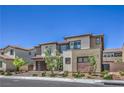 A modern two-story home with a two-car garage, and desert landscaping at 201 Carmel Sky St, Las Vegas, NV 89138