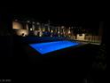 Backyard swimming pool with lighting to highlight the landscaping and block walls at 201 Carmel Sky St, Las Vegas, NV 89138