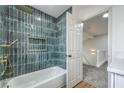 Upstairs bathroom with stylish blue tile in shower, and a view of the landing and stairs at 2107 Fountain Springs Dr, Henderson, NV 89074