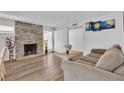 Inviting living room featuring a stone fireplace, ample natural light, and modern flooring at 2749 Heritage Cir, Las Vegas, NV 89121