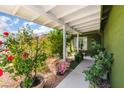 Charming front porch adorned with lush greenery and vibrant flowers at 3617 Walnut Wood St, Las Vegas, NV 89129