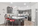 Modern kitchen with stainless steel appliances, granite countertops and a cozy breakfast bar at 3632 Julia Waldene Ct, Las Vegas, NV 89129