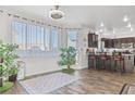 Bright living room featuring a large window, indoor plants and wood flooring at 3632 Julia Waldene Ct, Las Vegas, NV 89129