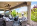 Cozy covered patio with comfortable seating and an outdoor fireplace, perfect for relaxing at 3698 Regatta Landing Dr, Las Vegas, NV 89141
